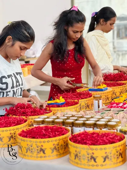 A close-up shot of our team members assembling festive hampers. Their focused expressions and skilled hands show the dedication and attention to detail that goes into every gift we produce.