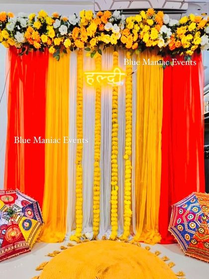 Another view of the red and yellow Haldi backdrop, perfect for small home functions.