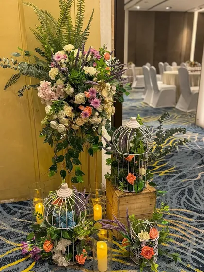 Elegant floral arrangements with rustic birdcages and wooden crates, creating a charming entrance piece.