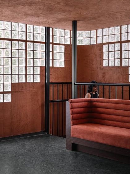 A view of the transition between levels at Idylll, where the earthy tones and textures are consistent, creating a cohesive journey through the space.