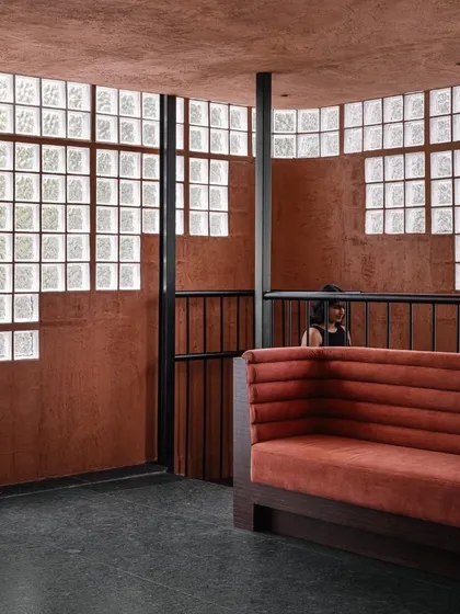 A view of the transition between levels at Idylll, where the earthy tones and textures are consistent, creating a cohesive journey through the space.