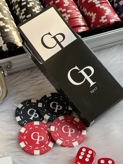 The sleek, black custom card boxes for the poker set, personalized with the couple's initials and wedding date.