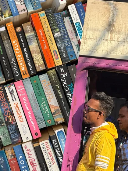 A collage of street market scenes, including colorful stacks of books and people peering into a bus.