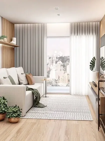 A bright and airy living room with a simple white sofa and a floating TV unit. The design is minimalist and makes the most of the natural light from the balcony.