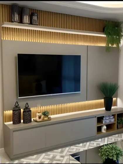 A chic and contemporary TV wall unit with soft backlighting on the wooden slat panels. The neutral grey console offers ample storage, making this design a perfect blend of modern aesthetics and practical living room organization.