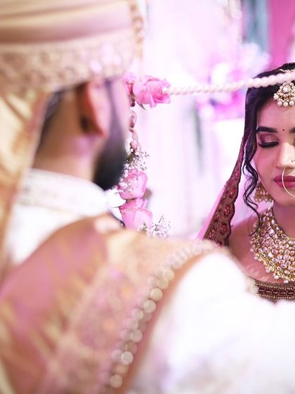 A candid moment from the varmala ceremony. The makeup is designed to look perfect in all lighting and during all the important rituals.