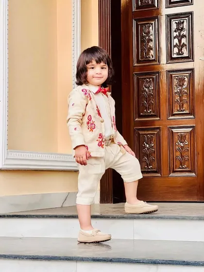 This look is all about formal charm for kids. The tailored embroidered jacket and shorts create a sophisticated silhouette, proving that high fashion has no age limit.