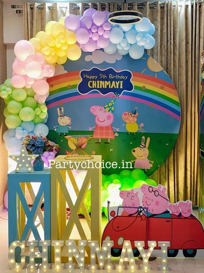 A Peppa Pig themed decoration designed for a home party. We used a round backdrop and colorful props to transform the living space.