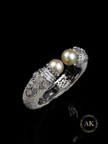 Jewellery can be wearable sculpture. This regal cuff is crafted with hundreds of tiny seed pearls, crowned with two natural golden South Sea pearls and a halo of fine diamonds. It’s a piece designed for the collector who appreciates artistry and emotion in equal measure.