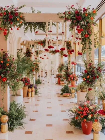 The full view of the Mamera ceremony walkway, adorned with lush floral arrangements and traditional hanging elements.