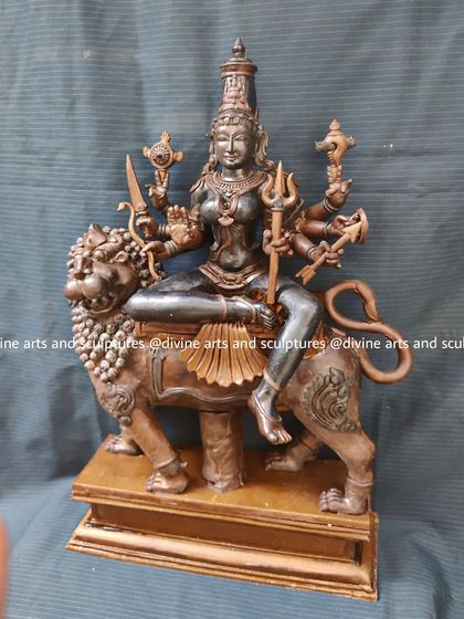 A wax model of Goddess Durga seated on her lion mount. This is a classic representation, and the wax stage allows us to perfect the posture and expression before casting.