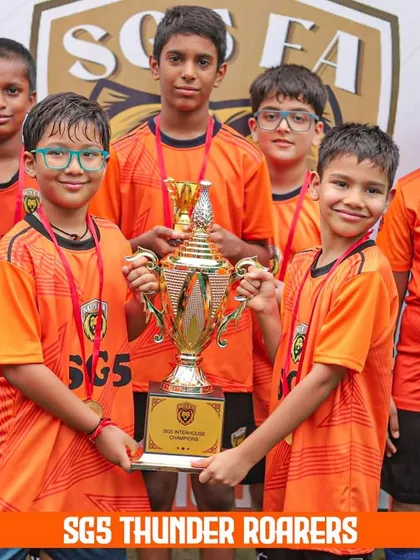 The young SGS Thunder Roarers proudly holding their championship trophy. Our tournaments give even the youngest players a taste of victory.