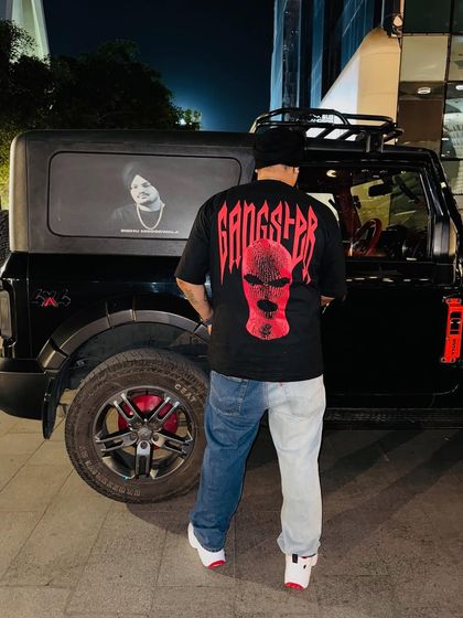 Showing off the back of the shirt and the ride. The gangster vibe is just for the look, the music is all about happiness.