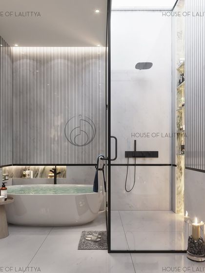 A bathroom designed not just for utility, but for pause. This space features a freestanding oval bathtub, a glass-enclosed shower with sleek black fixtures, and fluted wall panels, turning everyday routines into moments of quiet indulgence.