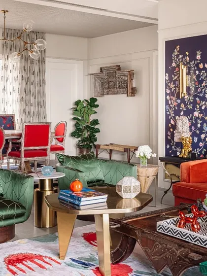 Another view of the "Box of Crayons" project, showing how the botanical wallpaper panels integrate with the eclectic and colorful decor of the living and dining areas.