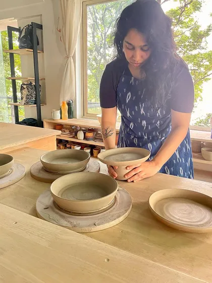 Lipika inspecting her freshly thrown bowls. Her superpower is throwing complex and beautifully balanced forms.