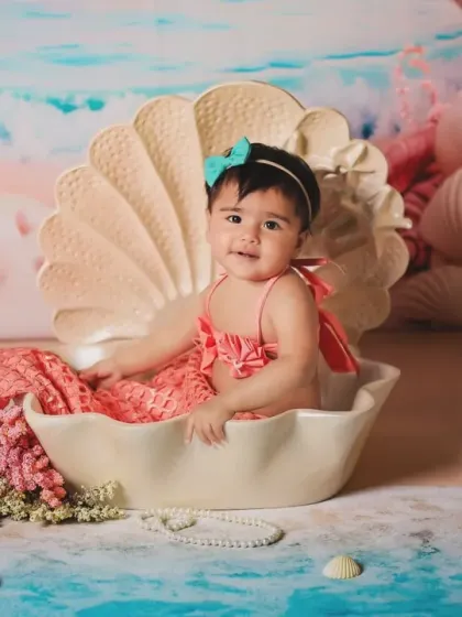 A curious little mermaid looking out from her shell. The colorful ocean backdrop is full of beautiful details.