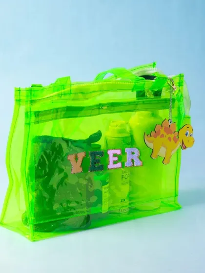 A neon green jelly bag, perfect for adding a pop of color to any outfit. It's shown here filled with essentials and personalised for 'Veer'.