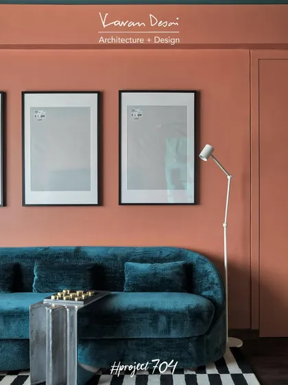 I love playing with bold color palettes that most people shy away from. In the living room for Project 704, we paired a deep teal velvet couch against a rich terracotta wall, creating a space that feels both energetic and sophisticated. The black and white striped rug adds a graphic punch to the room.