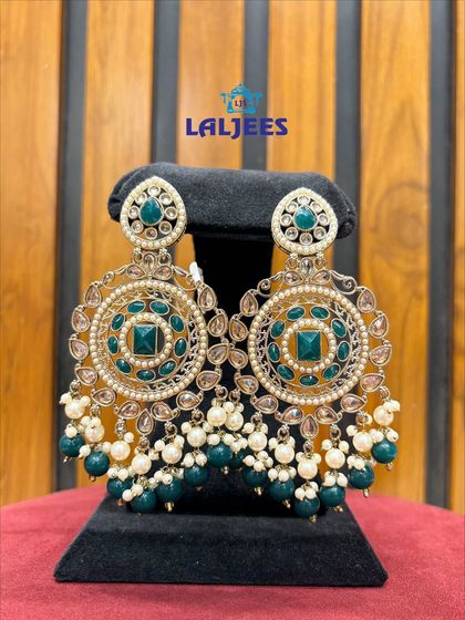 Stunning circular chandbalis with green stones and pearl drops. A perfect statement piece for a Mehendi function.