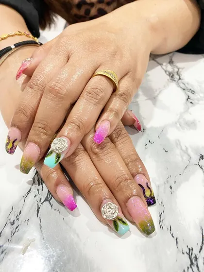 I'm so proud of my students' work. This fantasy nail set with multi-color ombre, flame details, and sculpted 3D roses was created by a student after just three days of training.