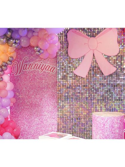 A close-up of our shimmering Barbie party decor. The combination of a sequin wall, a giant pink bow, and custom branding creates a glamorous and unforgettable photo backdrop.