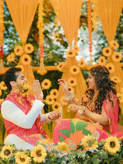 A candid moment of laughter and play during a sunflower-themed Haldi. These unscripted moments make the best memories.