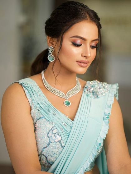 An eyes-closed shot to showcase the soft, blended eyeshadow and the radiant glow of her skin.