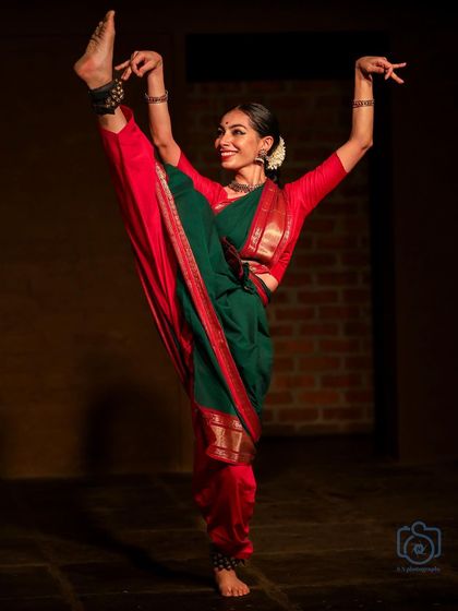 A dynamic pose from a Bharatanatyam performance at Natanakairali. This showcases the physical rigor and flexibility that classical dance demands, combining strength with grace.