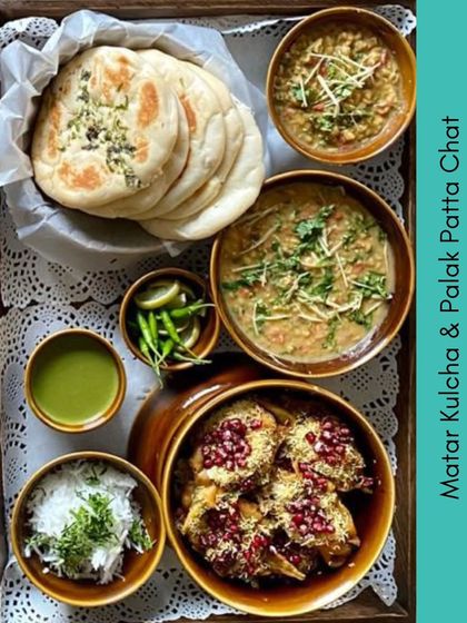 This platter from our Purani Dilli menu features Matar Kulcha and Palak Patta Chaat. It's a delicious combination of soft bread with a savory pea curry and crispy spinach chaat.