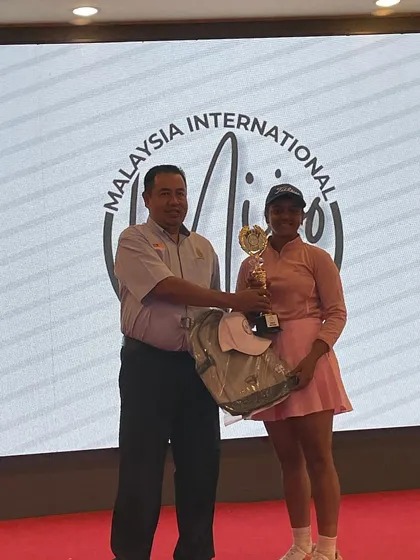 Riddhima Singh receives her 3rd place trophy at the Malaysian International Junior Open, where she competed against players from 11 countries.