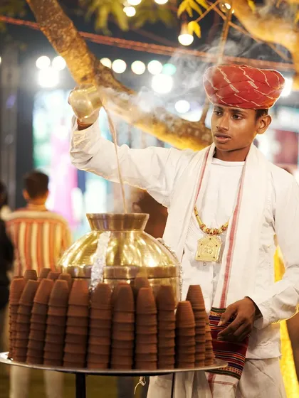 A server pours hot, aromatic masala chai at our traditional tea station. It's these small, authentic touches that make an event special.