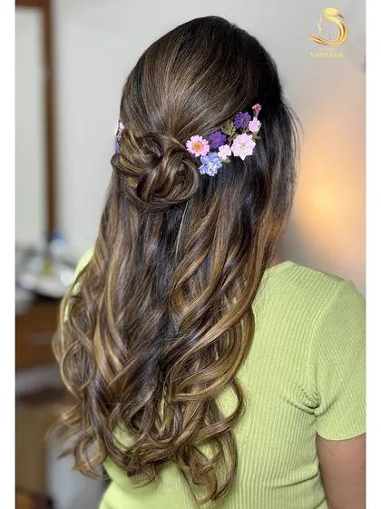 A closer look at the beautiful arrangement of pressed flowers in this unique hairstyle.