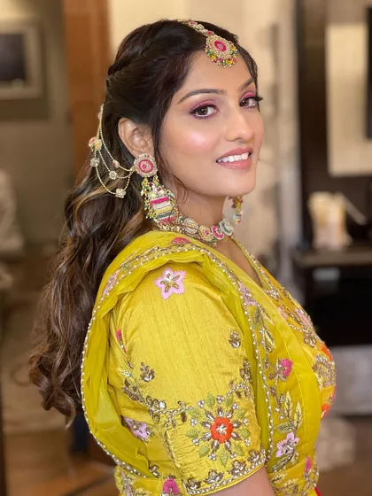 A side profile of the Haldi bride, her unique hairstyle looking beautiful.