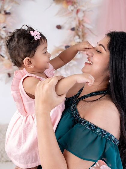 A mother is her daughter's first best friend. This sweet moment of a baby playing with her mommy's nose is pure, unfiltered love.