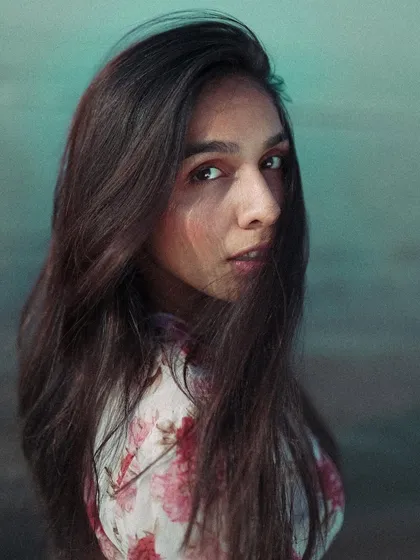 This is a close-up portrait where I played with hair movement to add a sense of candidness. The direct gaze of the model creates a strong connection with the viewer, making the image engaging.