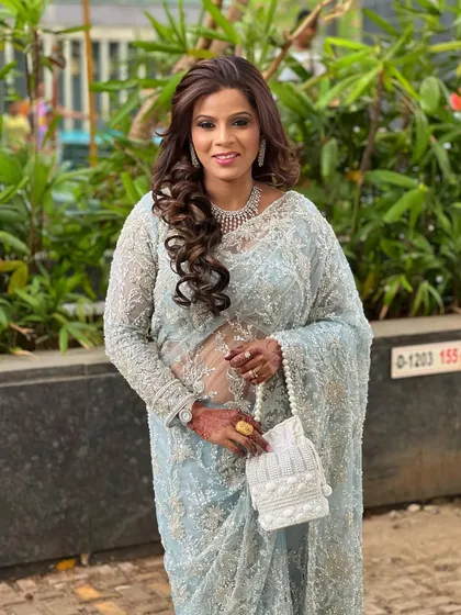 An elegant look for a bridesmaid or wedding guest. The model is wearing a powder blue saree with a delicate diamond necklace that adds a touch of sophistication.