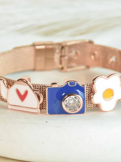 A few of our favorite things. This custom charm bracelet features a teapot, a camera, and a fried egg, showing that you can add any charms that represent your passions. It's quirky, cute, and totally you.