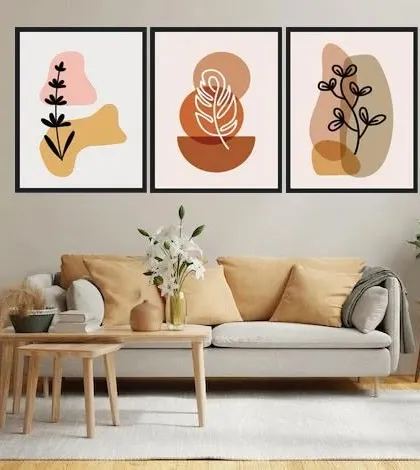This set of three framed art prints features botanical leaves and abstract shapes in a neutral, earthy palette. They are perfect for adding a calm, organic feel to a living room, with customization available for the frame, paper, and size.