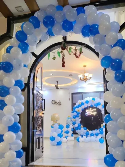 A grand entrance for a baby boy's welcome party. This large balloon arch in blue and white creates an impressive welcome for guests and makes the celebration feel special from the moment they arrive.