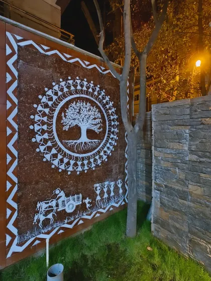 This is my Tree of Life Warli mural, painted on an exterior compound wall and seen here at night. The central tree symbolizes life and connection, surrounded by figures in a celebratory dance, creating a powerful piece of traditional Indian wall art.