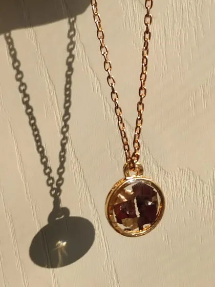 The sunlight catches the details in this rose gold pendant beautifully. I preserved crushed rose petals inside the circular bezel, creating a timeless piece of jewelry that holds a special meaning.