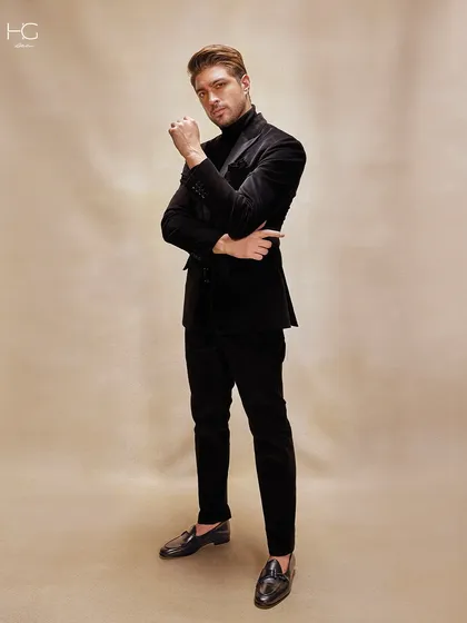 Texture tells a story. In this dark-hued corduroy suit, paired with a classic turtleneck, the narrative is one of depth, detail, and an undeniable presence, perfect for sophisticated evening events.