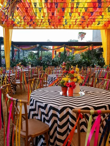 The guest dining area at the carnival, with chevron-print tables and chairs decorated with colorful ribbons, creating a cohesive and lively look.