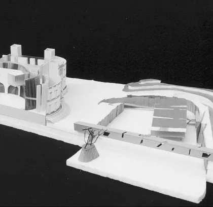 A physical model of the entire Minto Hall site proposal. It shows the relationship between the restored heritage building, the new convention facilities, and the surrounding landscape, including a proposed water channel along the lake.
