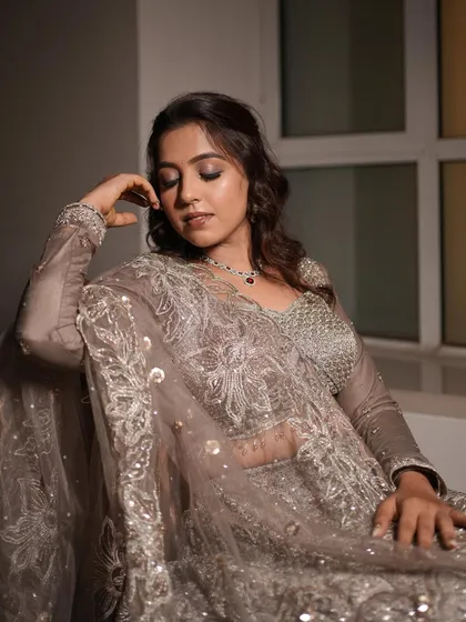 An elegant portrait of an engagement bride in a sophisticated grey lehenga. The makeup is soft and romantic.