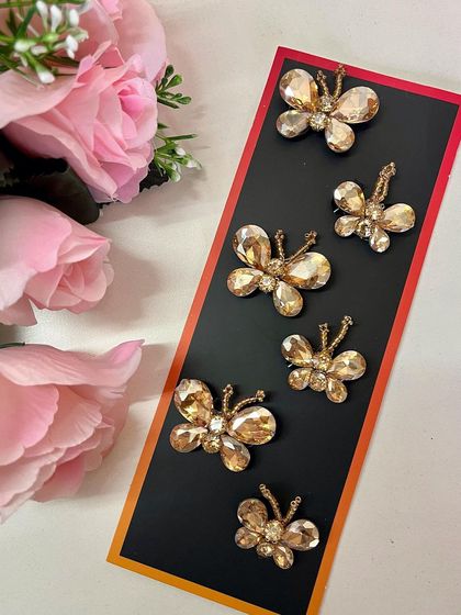 Butterfly kisses and fairy wishes. Elevate your hairstyle with these captivating gold butterfly hair accessories.