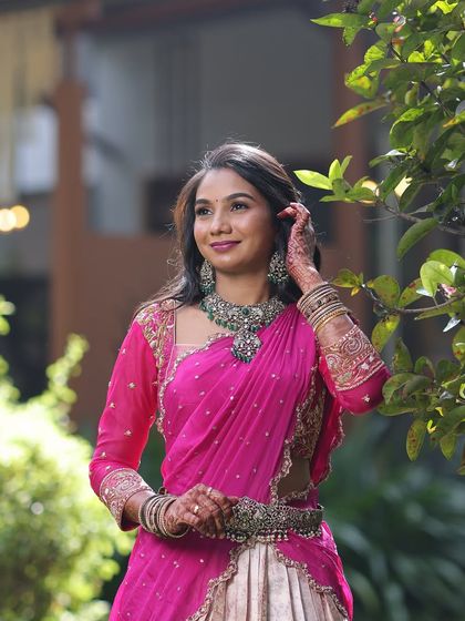 A candid moment showing the full look. Sanjana paired the Victorian necklace with a matching vaddanam (waist belt), creating a cohesive and stylish ensemble with her pink lehenga.