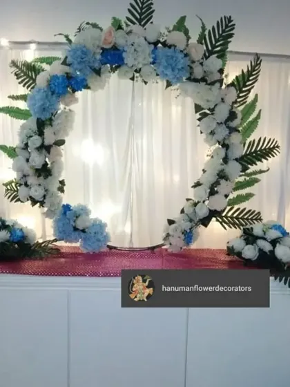For a minimalist aesthetic, I designed this simple half-arch floral frame. Made with white and blue artificial flowers, it's a clean and modern way to decorate your mandir space for Ganesh Chaturthi.