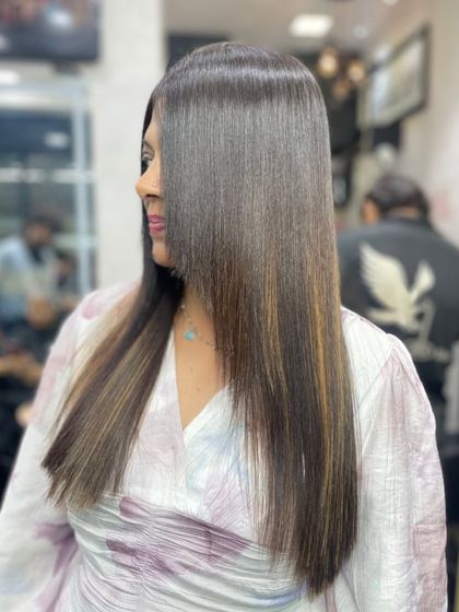 A sleek, modern look achieved through a professional straightening treatment. This service is ideal for clients who want to eliminate frizz and cut down on daily styling time.